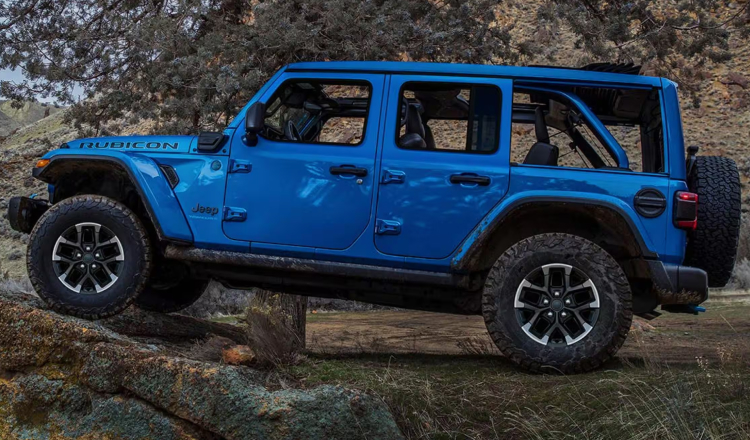 Blue Jeep Wrangler driving above terrain